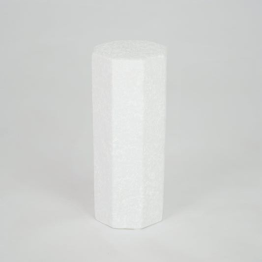 White geometric ceramic vase for modern shelf placement and contemporary indoor home decor styling accent piece.