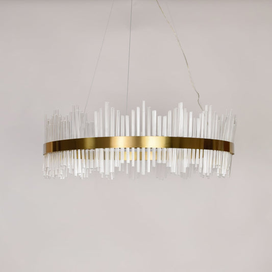 Linear chandelier with clear glass rods and gold metal frame suspended on off white background for luxury interior lighting.