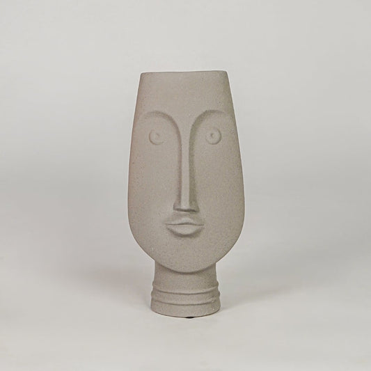Beige face ceramic vase for modern shelf placement and elegant indoor home decor styling accent piece.