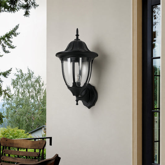 Black metal outdoor lantern wall light lifestyle image with warm glow for classic exterior entryway decor.