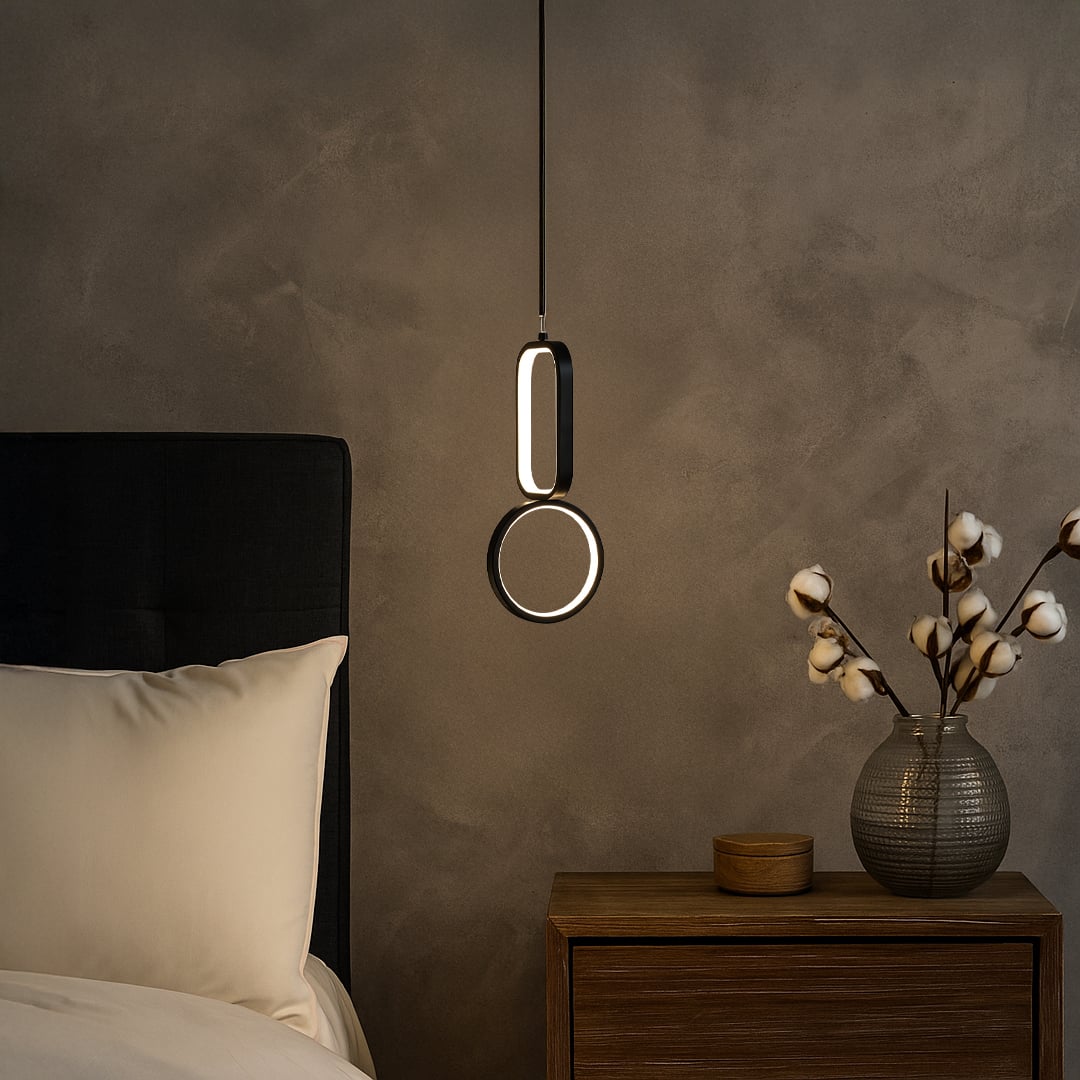 Gold metal LED wall light with warm glow enhancing bedside decor in modern bedroom interiors.