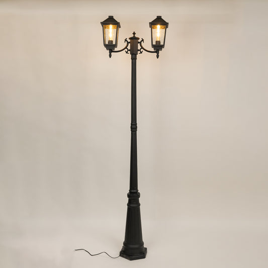 Decorative black outdoor street lamp with warm glowing lanterns for luxury exterior decor use.