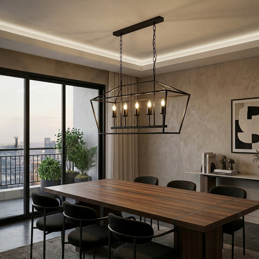 Black metal linear chandelier with exposed bulbs installed above wooden dining table in modern dining room with large windows and natural light.