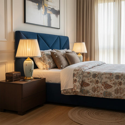Charming light blue ceramic table lamp with gold base and floral patterns blends traditional artistry and modern elegance for stylish bedroom lighting decor.