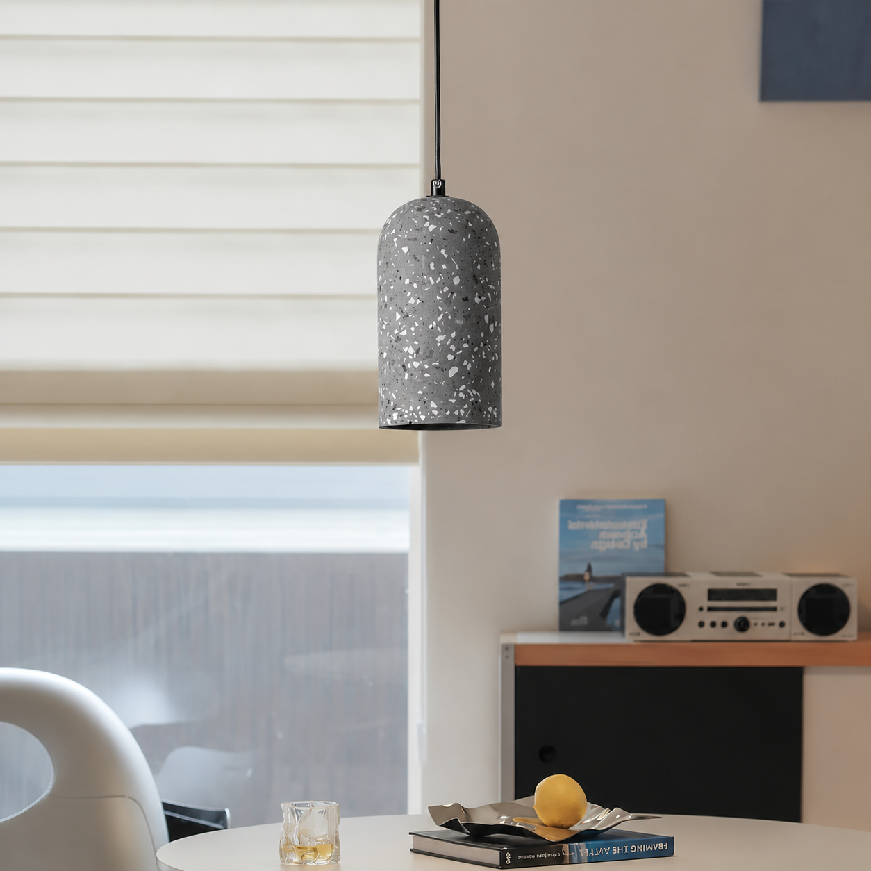Lifestyle image of nordic terrazzo cement pendant light in dark grey for elegant dining room decor styling and lighting.