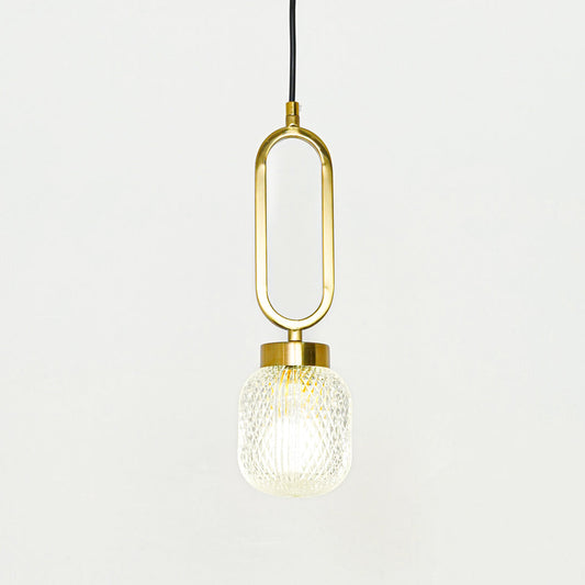 Modern gold hanging pendant light with elongated oval frame and textured glass bulb on clean background ideal for contemporary home decor lighting.