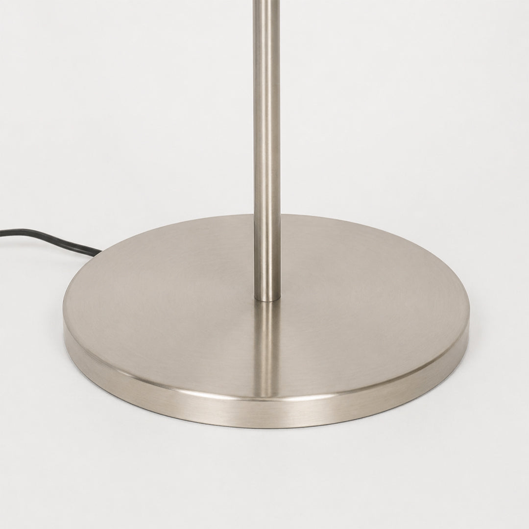 Closeup image of linear silver metal floor lamp base for elegant living room decor styling and modern home lighting setup.
