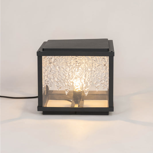 Black outdoor wall light with textured glowing glass panels for luxury exterior decor styling use.