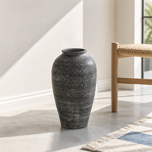 Lifestyle image of grey ceramic floor vase for modern living room decor styling with rustic textured finish.