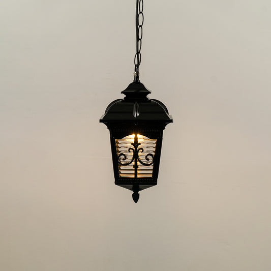 Black metal hanging outdoor lantern with decorative glass panels glowing on white background perfect for gate entrance and exterior decor lighting.
