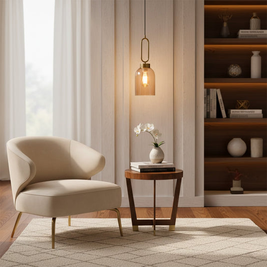 Modern amber glass pendant light hanging in a cozy living room beside a lounge chair and side table creating warm ambient decor lighting with light on.