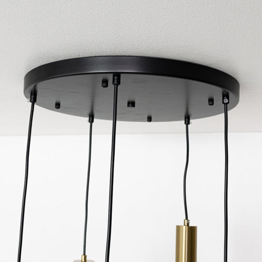 Close view of white globe pendant lights with gold metal holders highlighting their smooth modern finish for stylish interior lighting design.