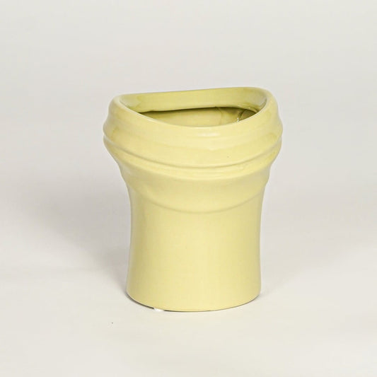 Minimal yellow ceramic decor vase with rounded shape and polished surface designed for tabletop floral arrangements.