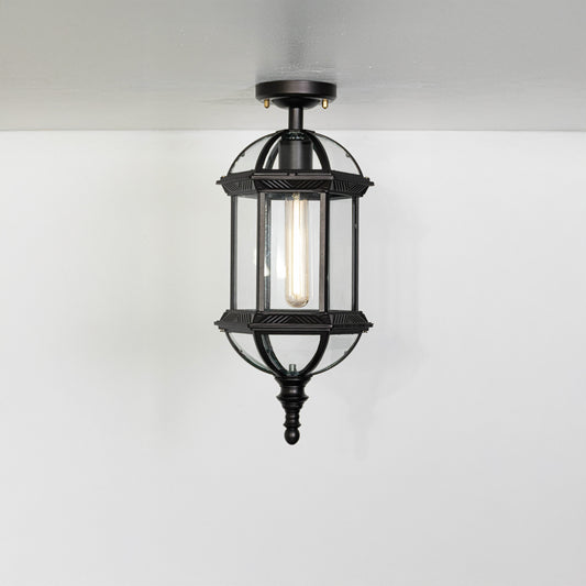 Vintage black metal lantern ceiling light with exposed bulb for classic entryway and traditional decor spaces.