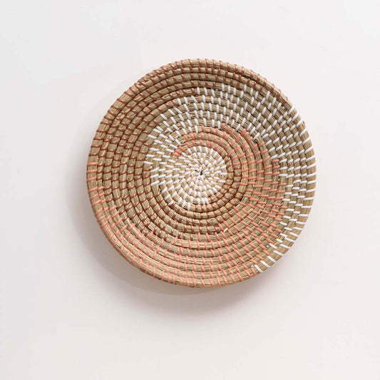 Natural woven decorative wall basket with spiral design for elegant wall styling and contemporary home decor.