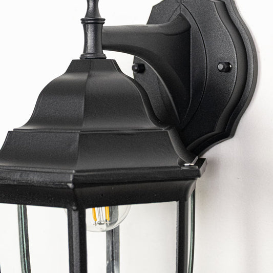 Closeup image of small Oxford outdoor wall lantern in black metal showing refined edges glass enclosure and compact exterior wall styling.