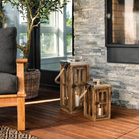 Modern wooden outdoor lantern set with clear glass panels creating warm ambient lighting for elegant porch and patio spaces.
