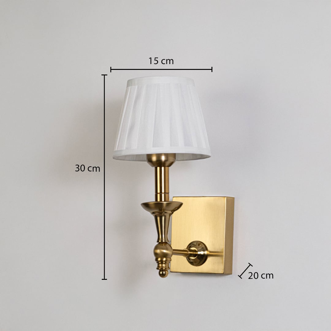 Gold metal wall sconce with white pleated shade shown with 30 cm height and 15 cm width for accurate size detail.