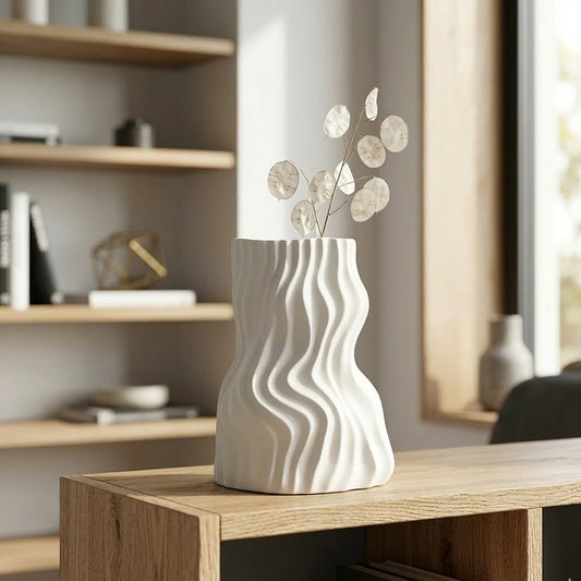 White ceramic decorative flower vase placed on table with flowers modern aesthetic home decor styling idea.