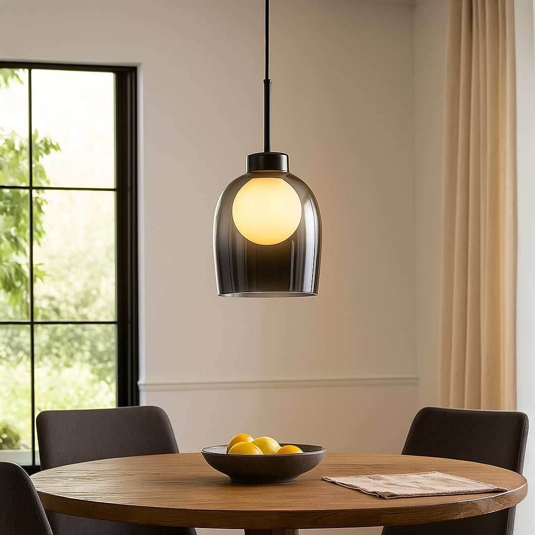 Smoked glass pendant light above dining table adding warm ambient lighting and contemporary elegance to home decor.