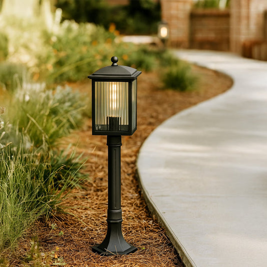 Modern black outdoor post light with ribbed glass body for garden and patio decor shown in a stylish lifestyle setting.