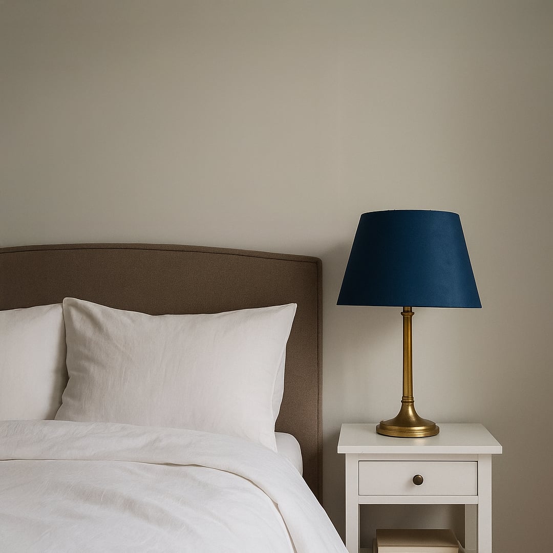 Blue tapered lampshade styled in a modern room adding a rich elegant accent while creating a soft warm glow for contemporary decor.