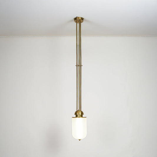 Gold metal and white glass pendant light with minimalist design for modern home decor spaces.