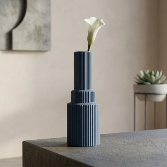 Blue ceramic decorative flower vase placed on table with flower modern minimal home decor styling idea.