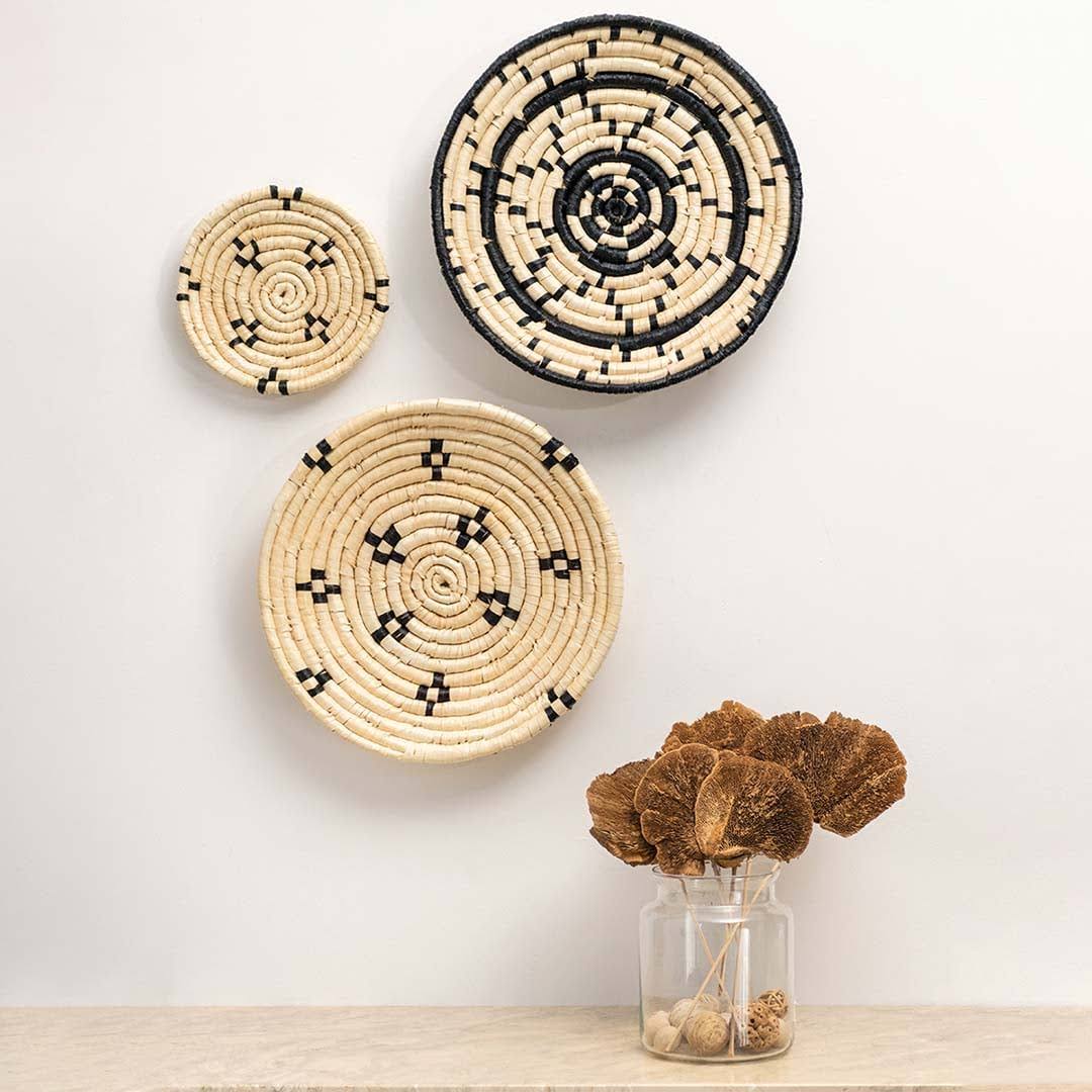 Handcrafted natural cream woven seagrass wall basket set displayed in bohemian lifestyle living room home decor styling.