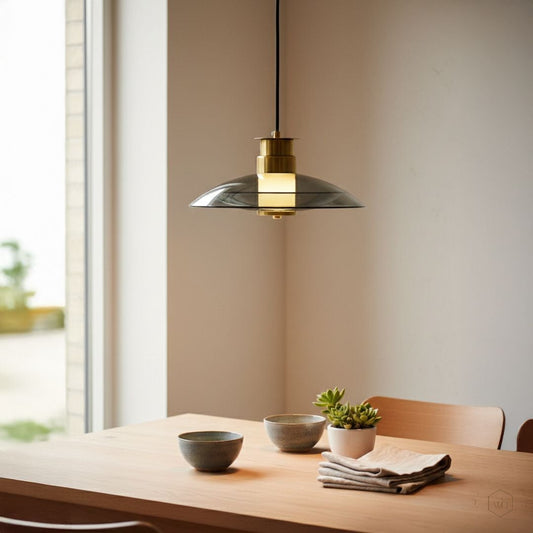 Black and gold metal disc pendant light adding warm elegance above the dining table in modern spaces.