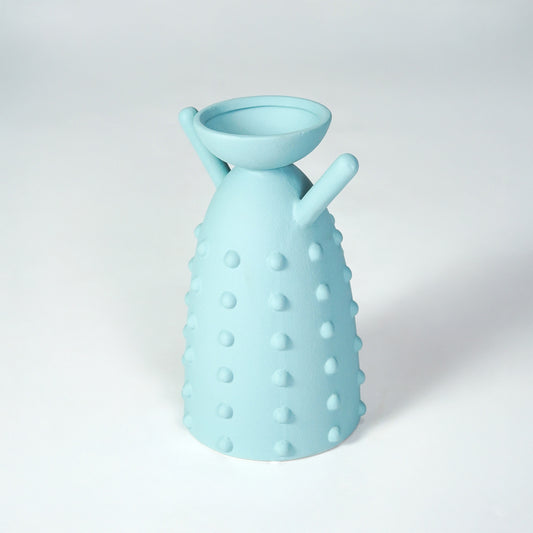 Light blue ceramic vase with textured design for modern shelf placement and artistic indoor decor styling accent.