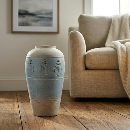 Lifestyle image of blue ceramic floor vase for modern living room decor styling with rustic textured finish.