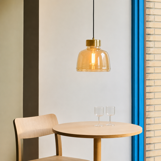Lifestyle image of sleek dome brass and amber pendant light for elegant dining room decor styling and modern home lighting.