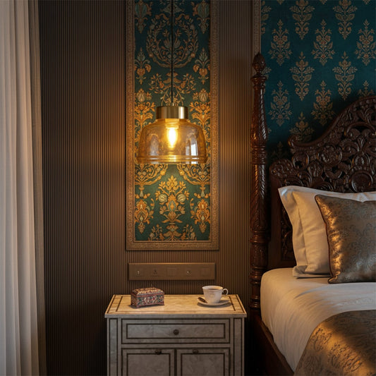 Amber glass pendant light hanging beside classic wooden bed illuminating patterned wall panel and bedside table creating warm luxurious bedroom atmosphere.