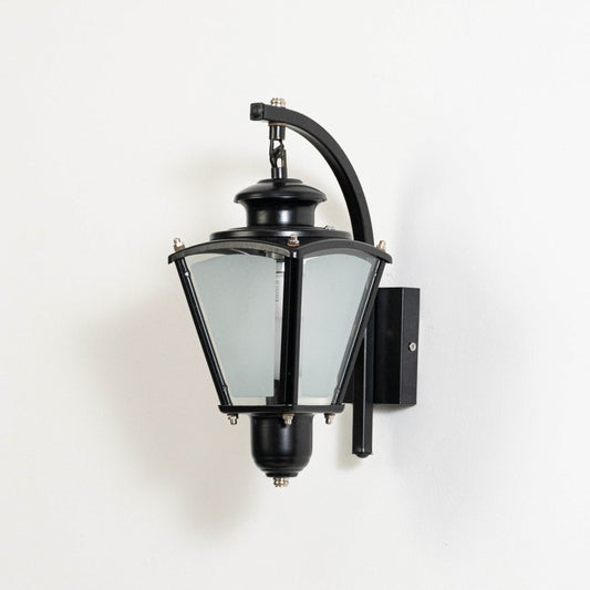 Classic outdoor wall lantern with black metal frame frosted glass panels and vintage design displayed on white background.