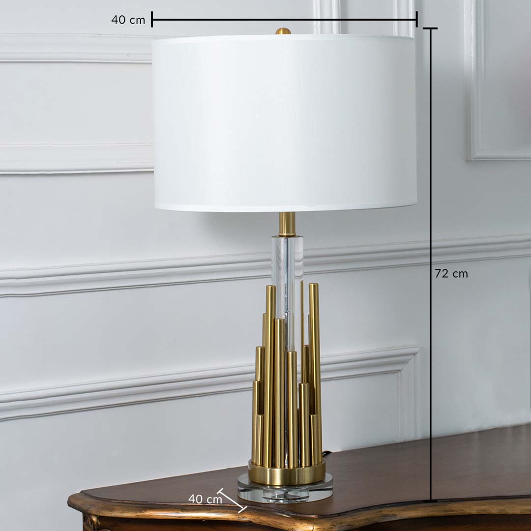 Gold metal table lamp with white drum shade and tiered cylindrical base shown with clear dimensions of 40 cm width 72 cm height and 40 cm depth ideal for bedside or living room placement.