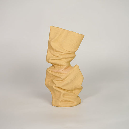 sorting hat crumpled ceramic vase yellow white background