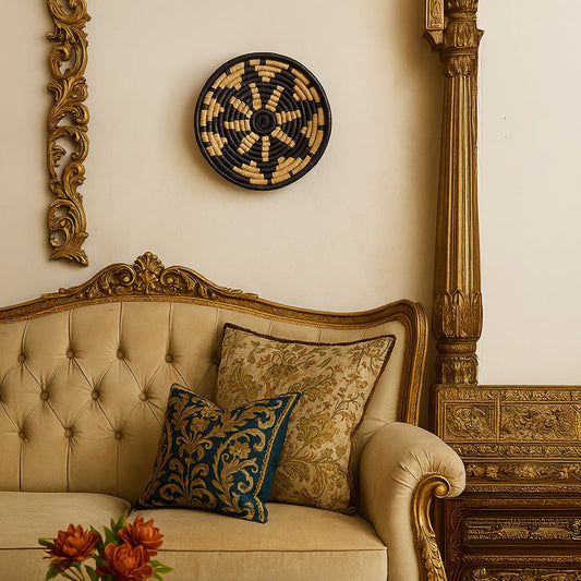 Black cane wall basket displayed above a vintage beige sofa with golden carved frame adding an elegant boho touch to the living room decor.