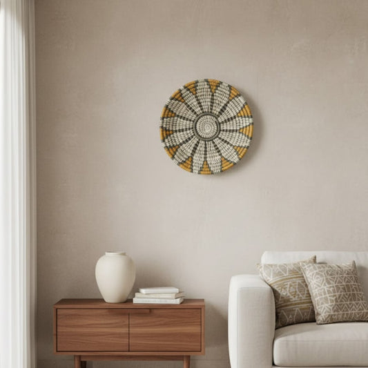 Circular wall decor in soft neutral and gold tones mounted above wooden console adding elegant focal point to calm modern living space.