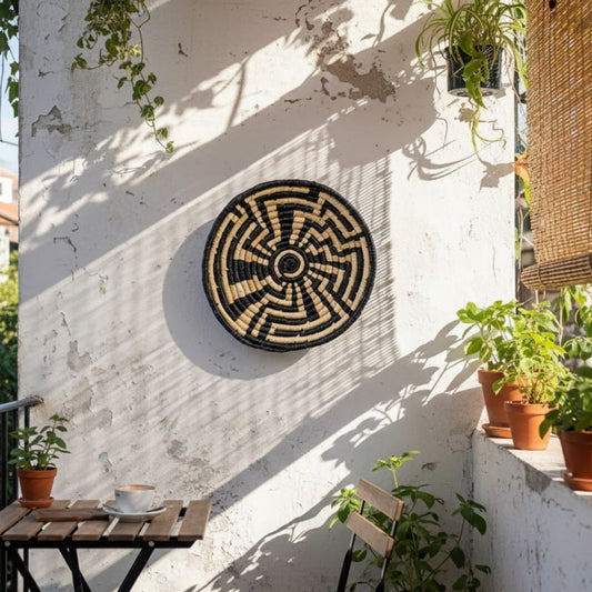 Nature inspired round wall decor mounted on balcony wall complementing plants and sunlight to create serene outdoor decor with organic visual balance.