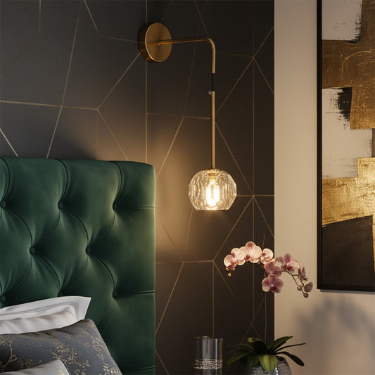 A gold metal wall light with a faceted crystal shade shown with clear dimensions displaying a height of 40 cm a width of 27 cm and a wall plate width of 11 cm.