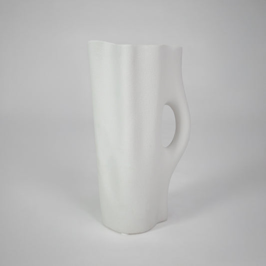 White background image of white ceramic handle vase for elegant tabletop decor styling with smooth matte finish.