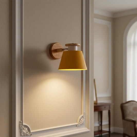 Modern mustard metal wall light with warm lighting for stylish bedroom and contemporary decor spaces.