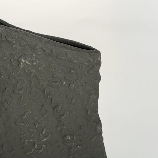 tombstone black ceramic vase closeup 1