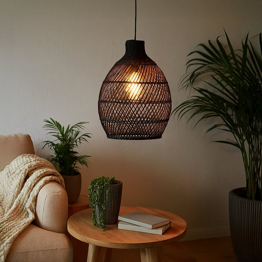 Black woven rattan pendant light adding a warm natural accent to modern interiors with its artistic handwoven organic design.