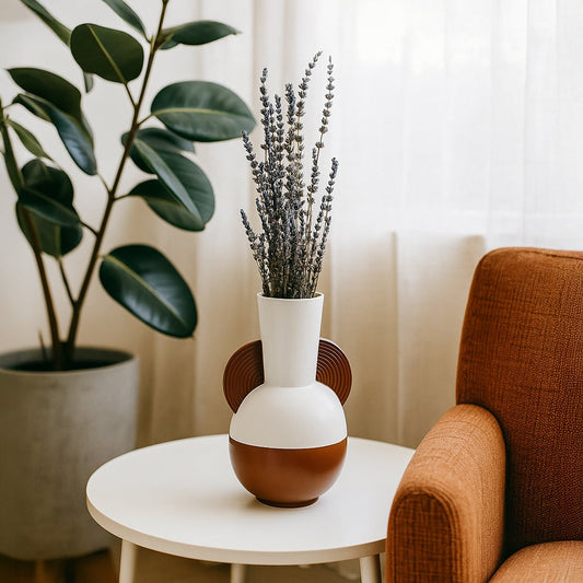 Modern ceramic vase in white and brown styled in a soft minimal setting adding an artistic touch to contemporary home decor.