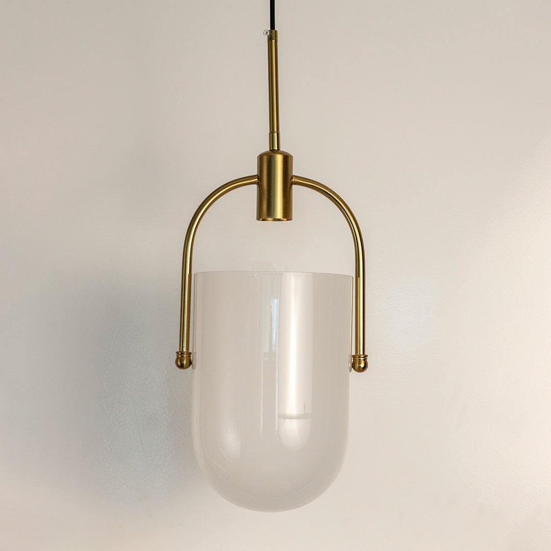 Frosted white glass pendant light with gold frame crafted for modern dining and living spaces.