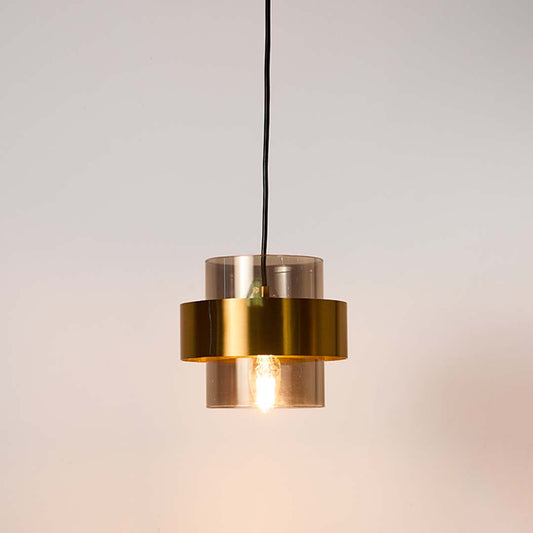 Clear glass and brass metal pendant light with layered design for stylish contemporary decor spaces.