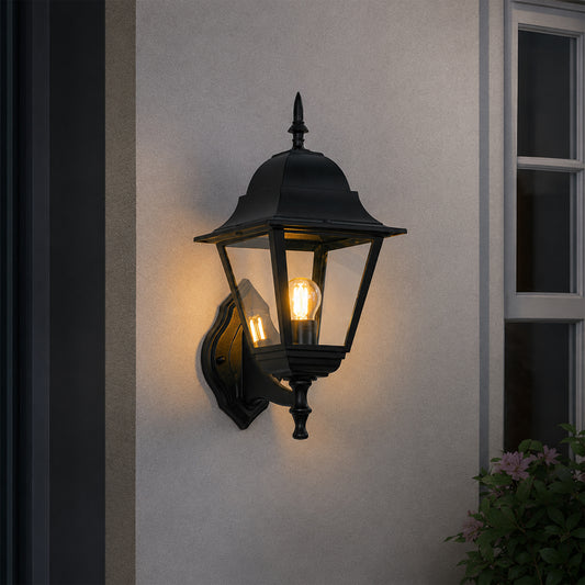 Black metal outdoor lantern wall light lifestyle image with warm glow for elegant exterior entryway decor.