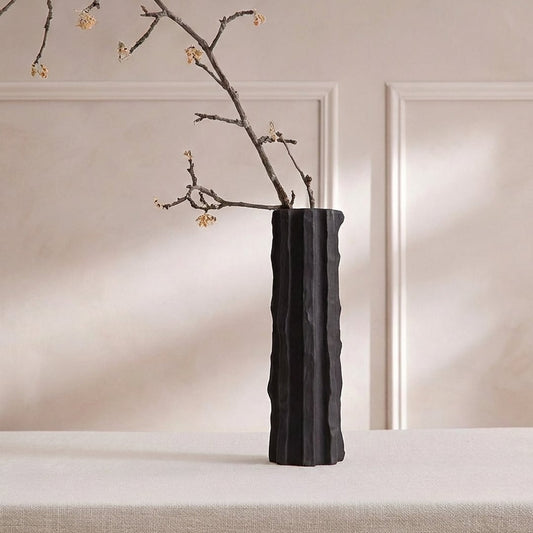 Black ceramic decorative floor vase with tall sculpted fluted design perfect for dried flower display in living room corner and modern home decor.